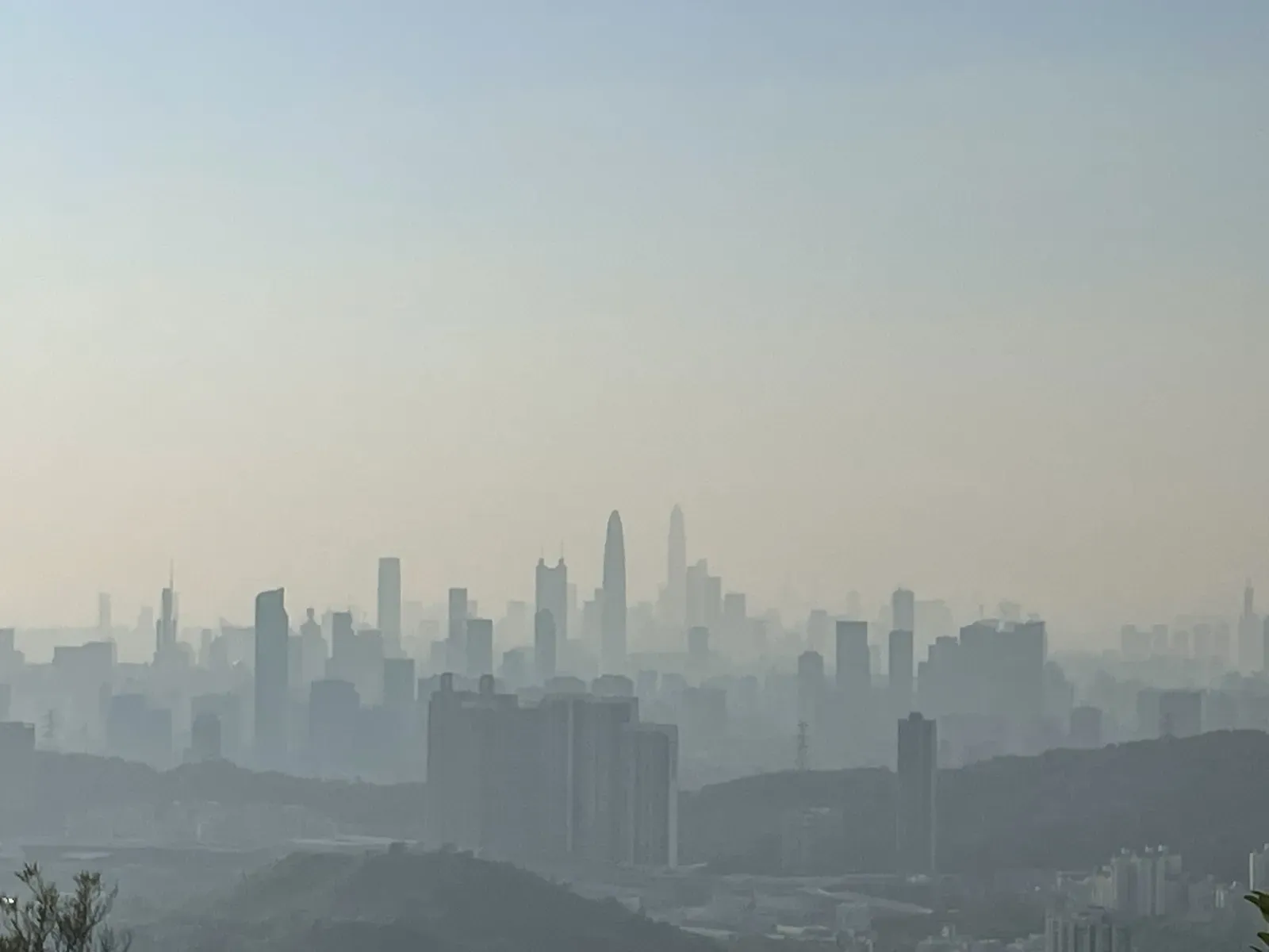 Distant skyline fading into pale haze beyond low hills.